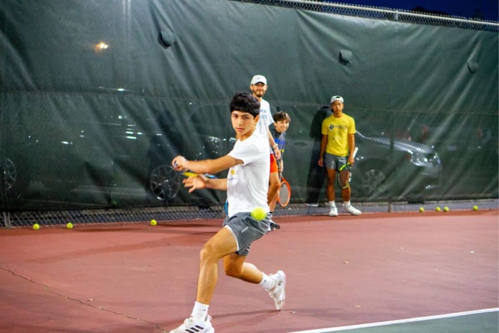 Homeschool Tennis Lessons - Devin Mendez Homeschool Tennis Lessons - Devin Mendez hitting a slice