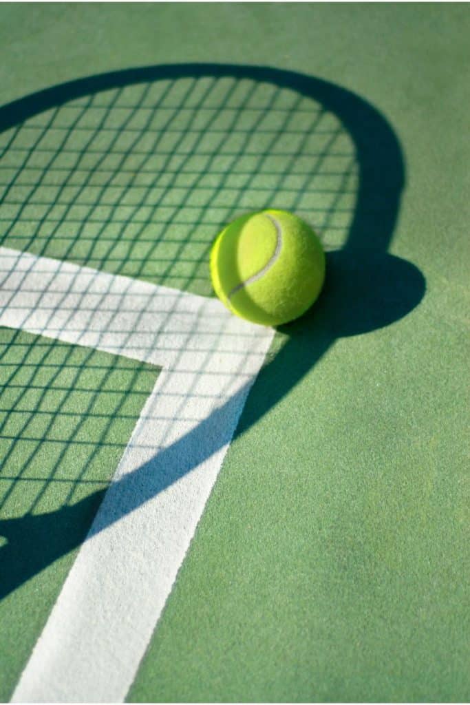 a racquet shadow on top of a tennis ball a racquet shadow on top of a tennis ball